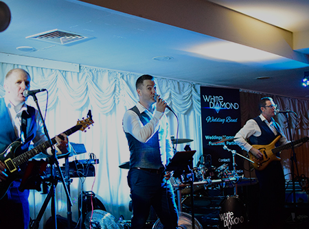 White Diamond Lead singer performing at a wedding